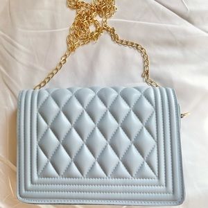 Blue quilted crossbody bag.